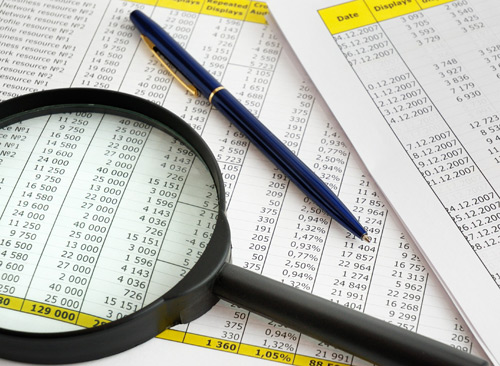 magnifying glass, pen, financial statement