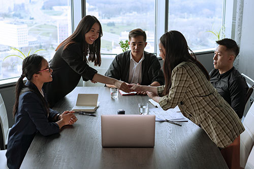 Several people holding a business meeting in a room